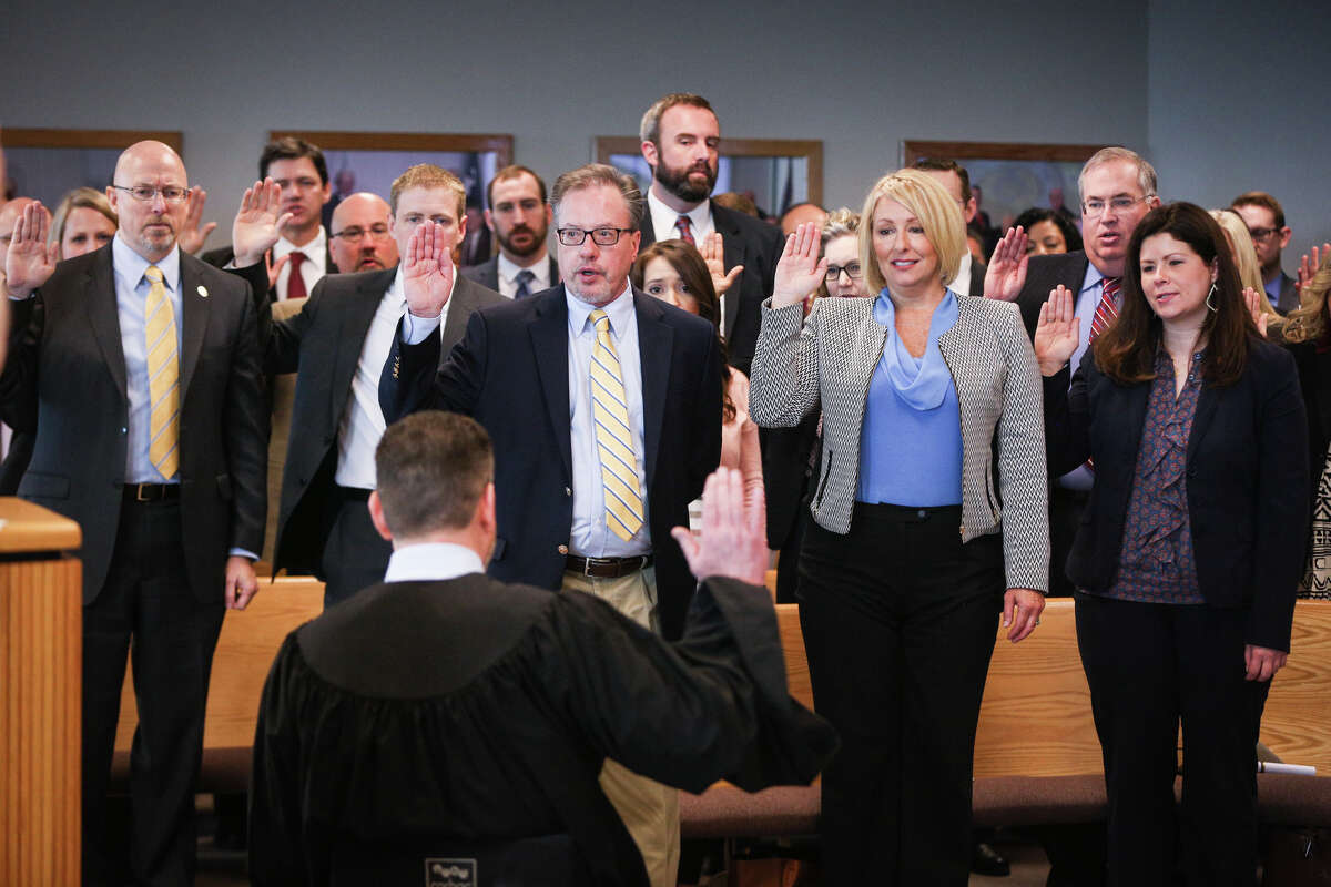 Judge Phil Grant swears in the assistant district attorneys during the oath swearing ceremony on Sunday, Jan. 1, 2017, at the Alan B. Sadler Commissioners Court Building.