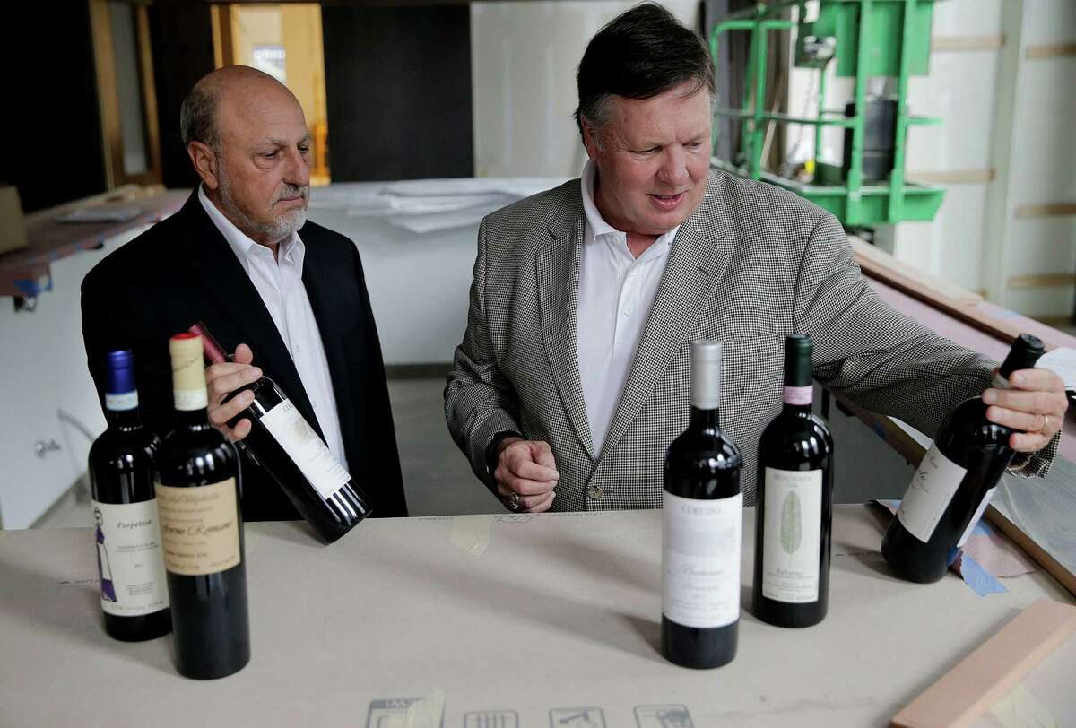 Bill Floyd, right, and Rick Jamail go over the wine for the new high-end Italian Restaurant on Thursday, Dec. 29, 2016, in Houston. ( Elizabeth Conley / Houston Chronicle )