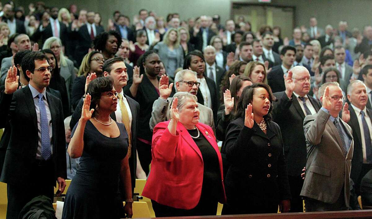 Staff members are sworn in by Harris County District Attorney Kim Ogg during her inauguration Monday.