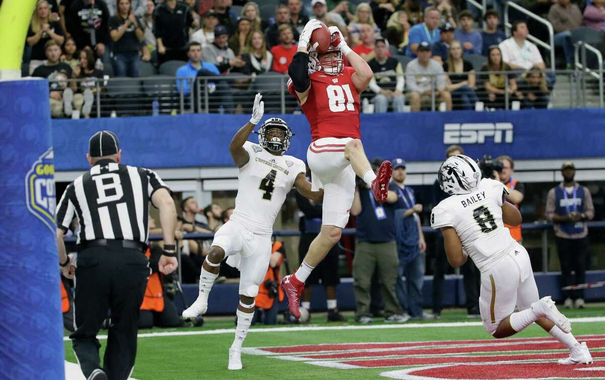Whether on the ground, as with his one-handed snag, above, or in the air like on a touchdown reception during the fourth quarter, below, Wisconsin tight end Troy Fumagalli put on a show Monday.