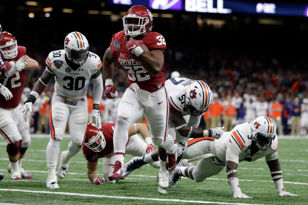 Samaje Perine, who later would pass Billy Sims to become Oklahoma's all-time leading rusher, leaves Auburn defenders in his wake on a fourth-quarter touchdown run.