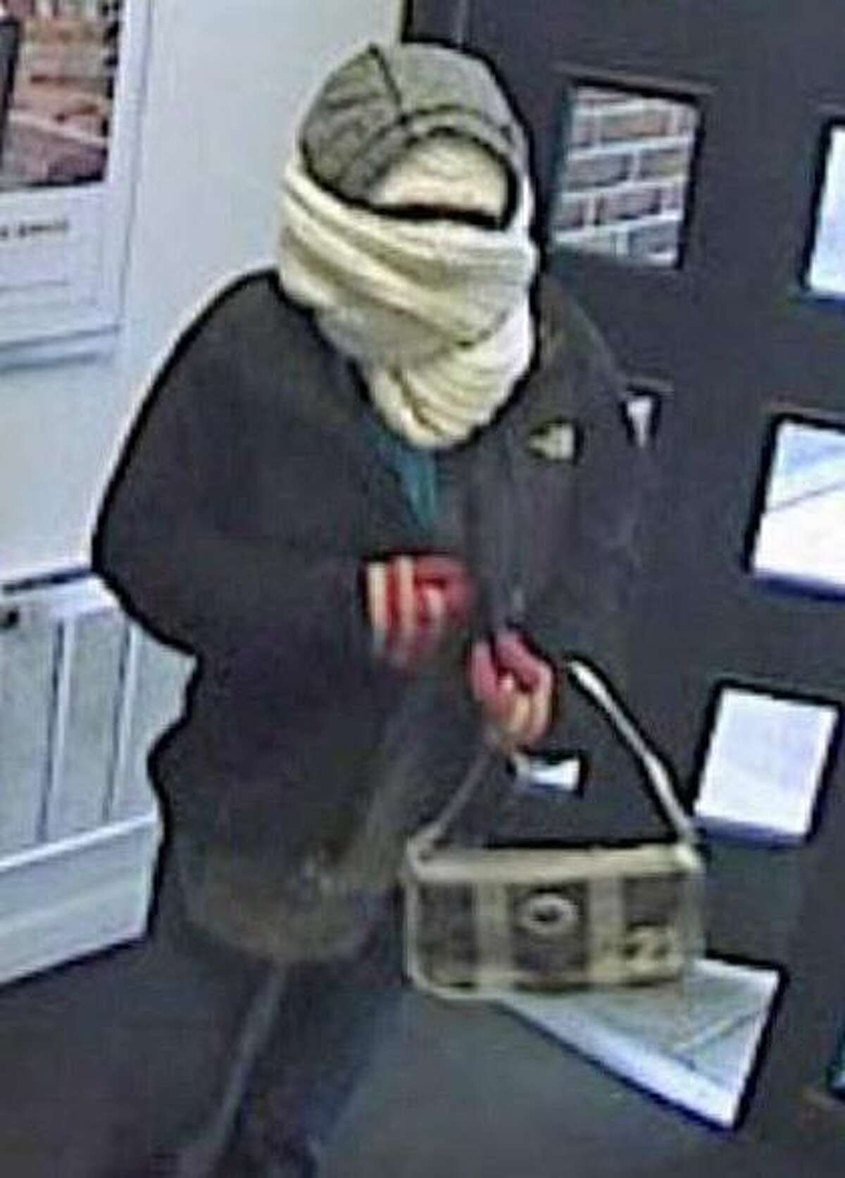 Woman with hat, scarf hiding face, robs bank