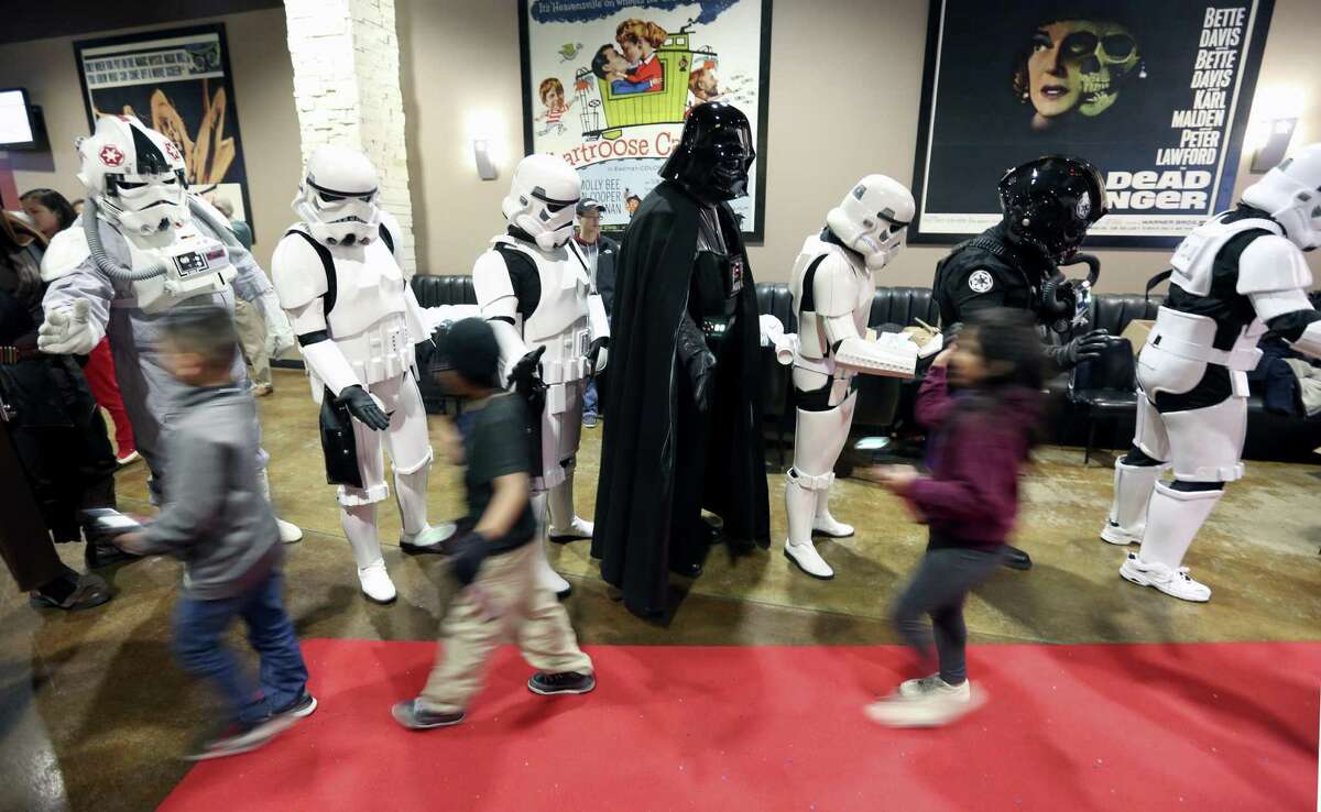 Children from San Antonio-area Boys and Girls Clubs are greeted Tuesday morning, Dec. 20, 2016 by Star Wars characters as they enter Alamo Drafthouse for a screening of Rogue One through an event coordinated by District 1 councilman Roberto Trevino.