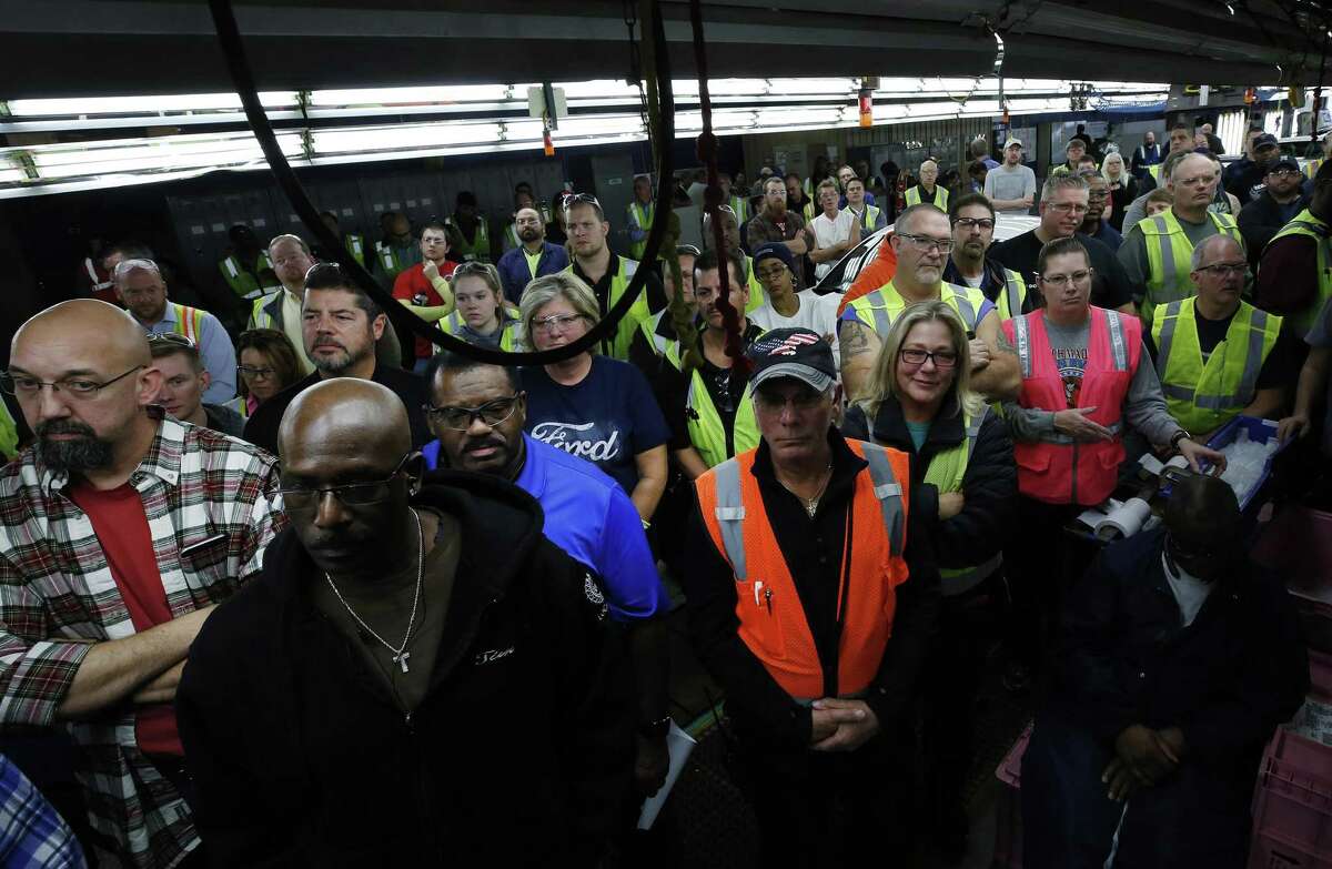 Workers listen as Mark Fields, CEO of Ford Motor Co., not pictured, speaks during a news conference at the company’s assembly plant in Flat Rock, Michigan. Ford will invest $700 million in the Michigan plant to build new electric and autonomous vehicles. The factory will get 700 new jobs.