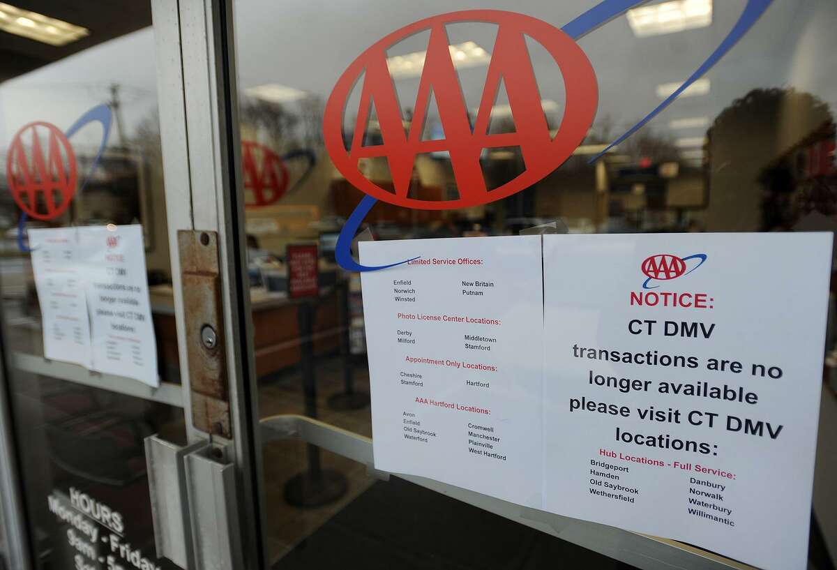 Signs announcing that DMV transactions are no longer available at AAA's offices in Fairfield, Conn. on Tuesday, January 3, 2017.