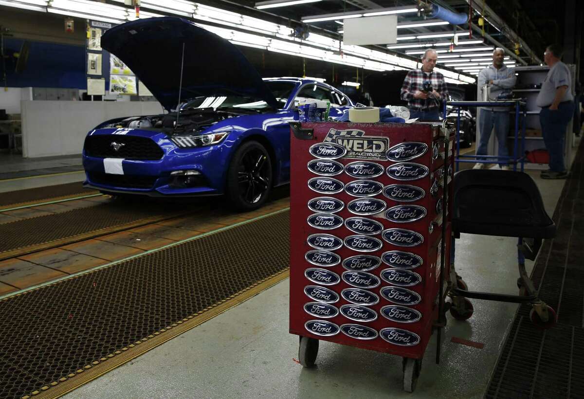 A Ford Motor Co. Mustang vehicle stands on the production line at the company’s assembly plant in Flat Rock, Michigan. CEO Mark Fields says Ford planned to use the Flat Rock plant to produce gas-electric hybrid versions of its Mustang sports car and F-150 pickup truck, as well as a new battery-powered sport utility vehicle.