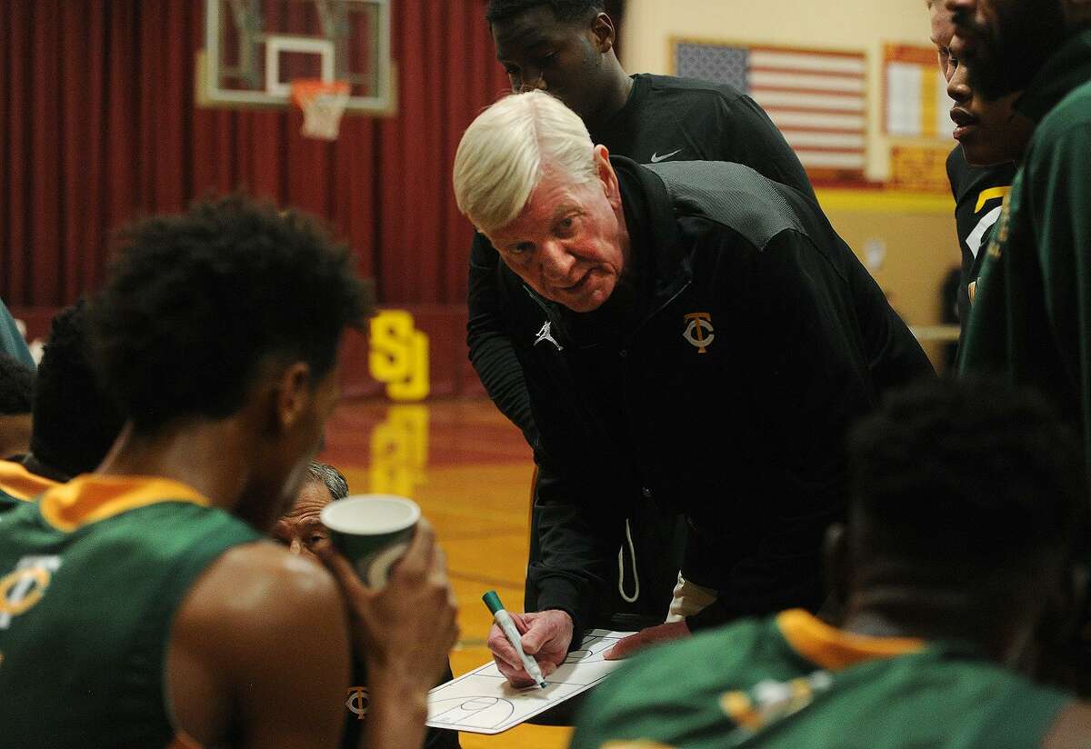 Trinity Catholic boys basketball coach Mike Walsh talks with his players during their 79-51 victory over St. Joseph in Trumbull on Tuesday.