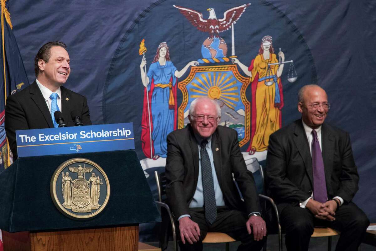 New York Gov. Andrew Cuomo, left, is joined by Vermont Sen. Bernie Sanders, center, and Chairperson of the Board of Trustees of The City University of New York William C. Thompson, as he speaks during an event at LaGuardia Community College, Tuesday, Jan. 3, 2017, in New York. Gov. Cuomo announced a proposal for free tuition at state colleges to hundreds of thousands of low- and middle income residents. Under the governor's plan, which requires legislative approval, any college student accepted to a New York public university or two-year community college is eligible, provided their family earns less than $125,000. (AP Photo/Mary Altaffer)