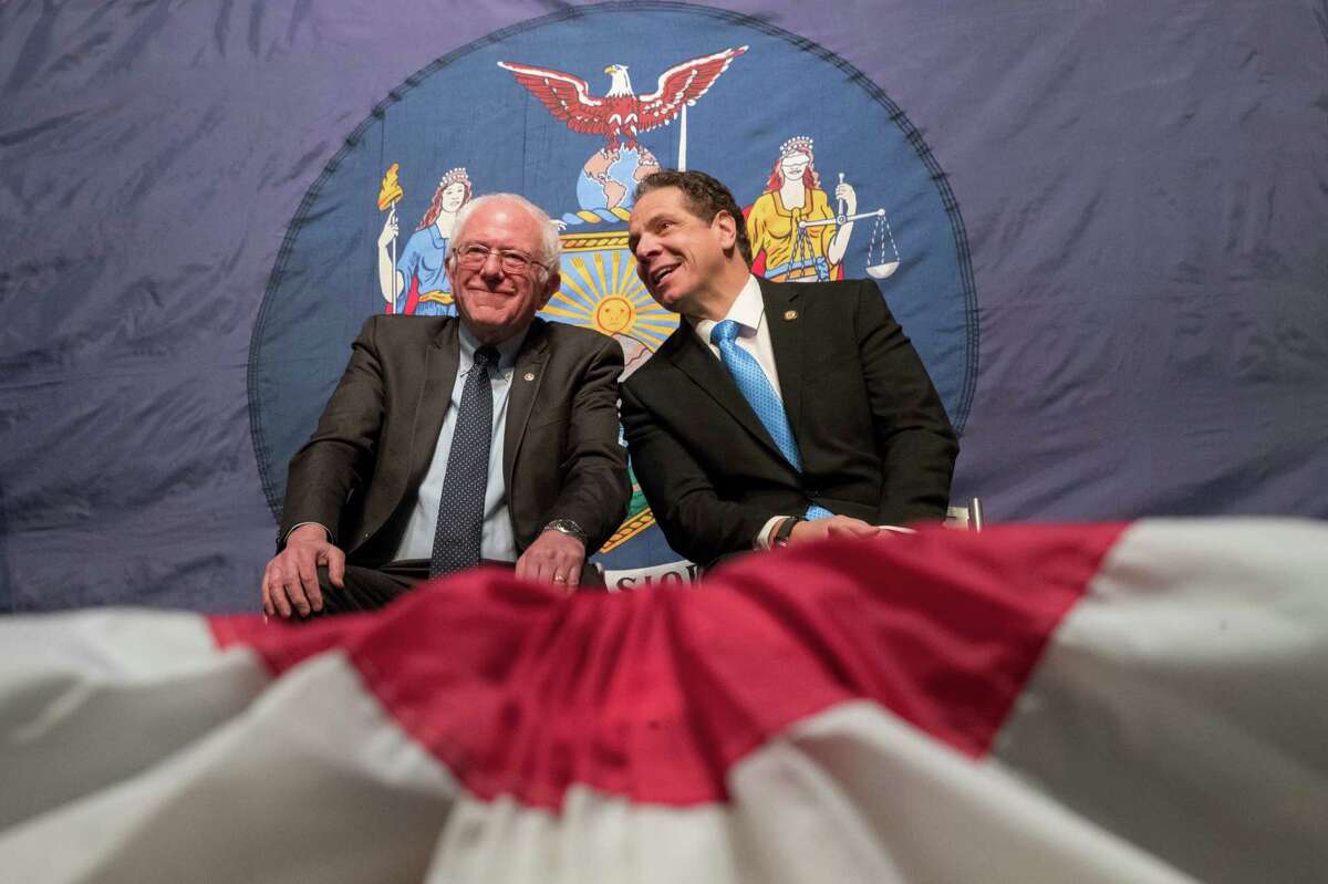 New York Gov. Andrew Cuomo, right, and Vermont Sen. Bernie Sanders appear onstage together during an event at LaGuardia Community College, Tuesday, Jan. 3, 2017, in New York. Gov. Cuomo announced a proposal for free tuition at state colleges to hundreds of thousands of low- and middle income residents. Under the governor's plan, which requires legislative approval, any college student accepted to a New York public university or two-year community college is eligible, provided their family earns less than $125,000. (AP Photo/Mary Altaffer) ORG XMIT: NYMA103