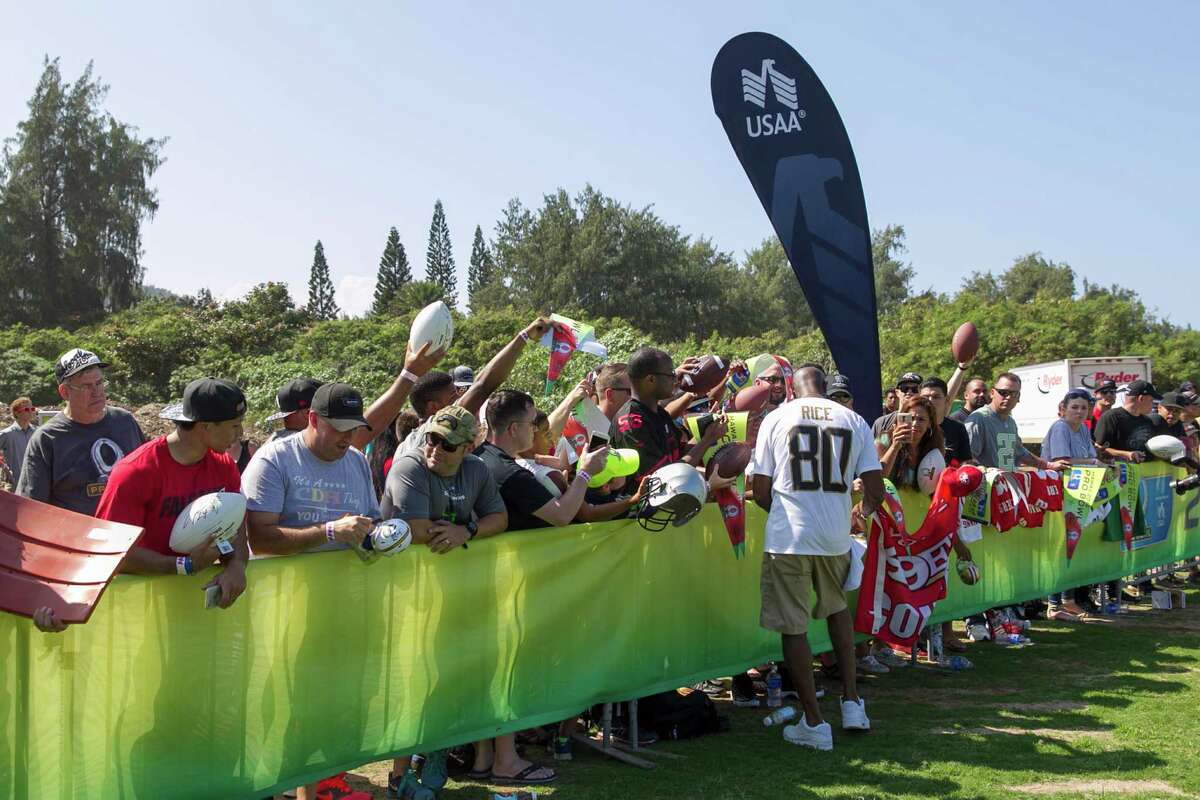 NFL legend Jerry Rice signs autographs for wounded veterans during the 2016 NFL Pro Bowl practice presented by USAA on Friday, Jan. 29, 2016 at Turtle Bay Resort in Kahuku, Hawaii. USAA is the Official Military Appreciation Sponsor of the NFL. (Marco Garcia/AP Images for USAA)