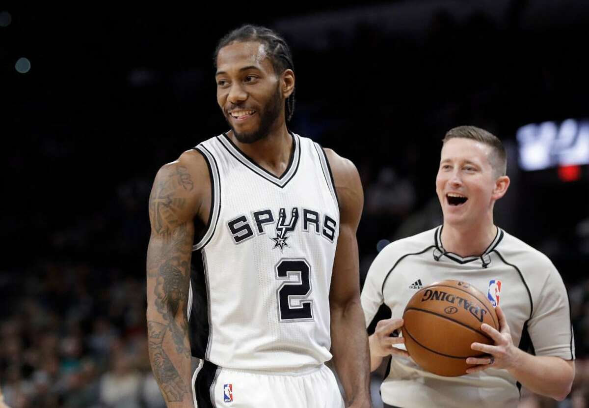 Kawhi Leonard and referee Nick Buchert are all smiles during the Spurs’ 110-82 rout of Toronto Tuesday at the AT&T Center.