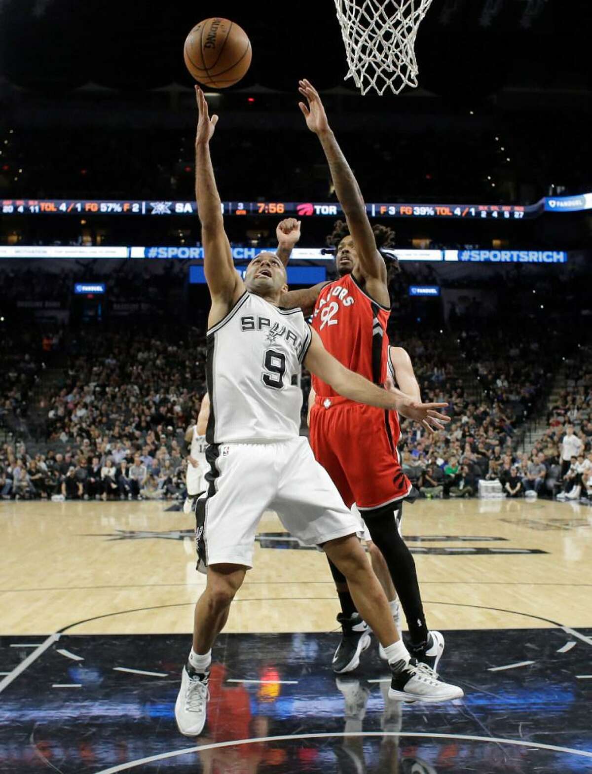 San Antonio Spurs guard Tony Parker shoots in the paint as Toronto Raptors center Lucas Nogueira defends during the Spurs’ lopsided win Tuesday at the AT&T Center. The Spurs are scoring less from the paint this year than in previous seasons, by design.