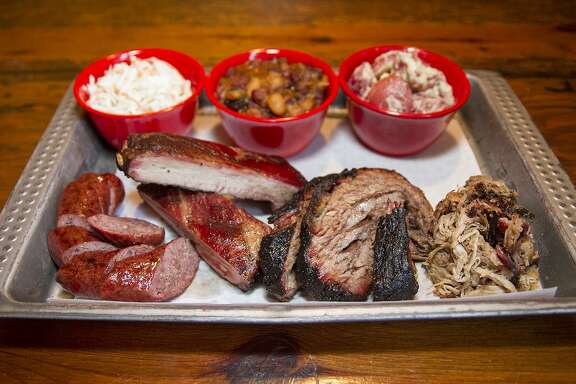 A barbecue lunch at The Granary ‘Cue and Brew might include sausage, pork ribs, brisket, pulled pork, cole slaw, beans and potato salad.