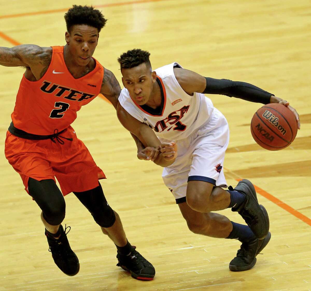 UTSA's Gino Littles looks for room around UTEP's Omega Harris during first half action Sunday Jan. 1, 2017 at the Convocation Center.