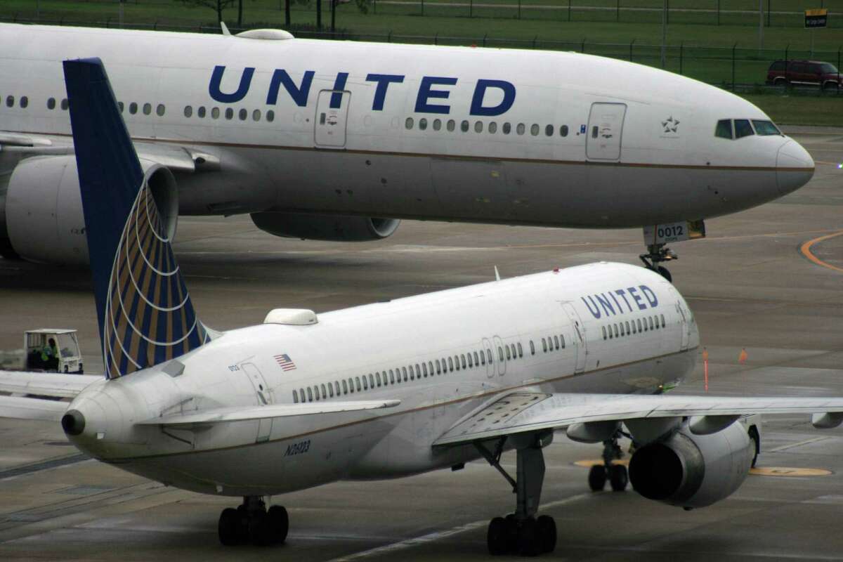 A United Airlines Boeing 777 passes in front of a United Airlines Boeing 757 at Bush Intercontinental Airport in December 2016.