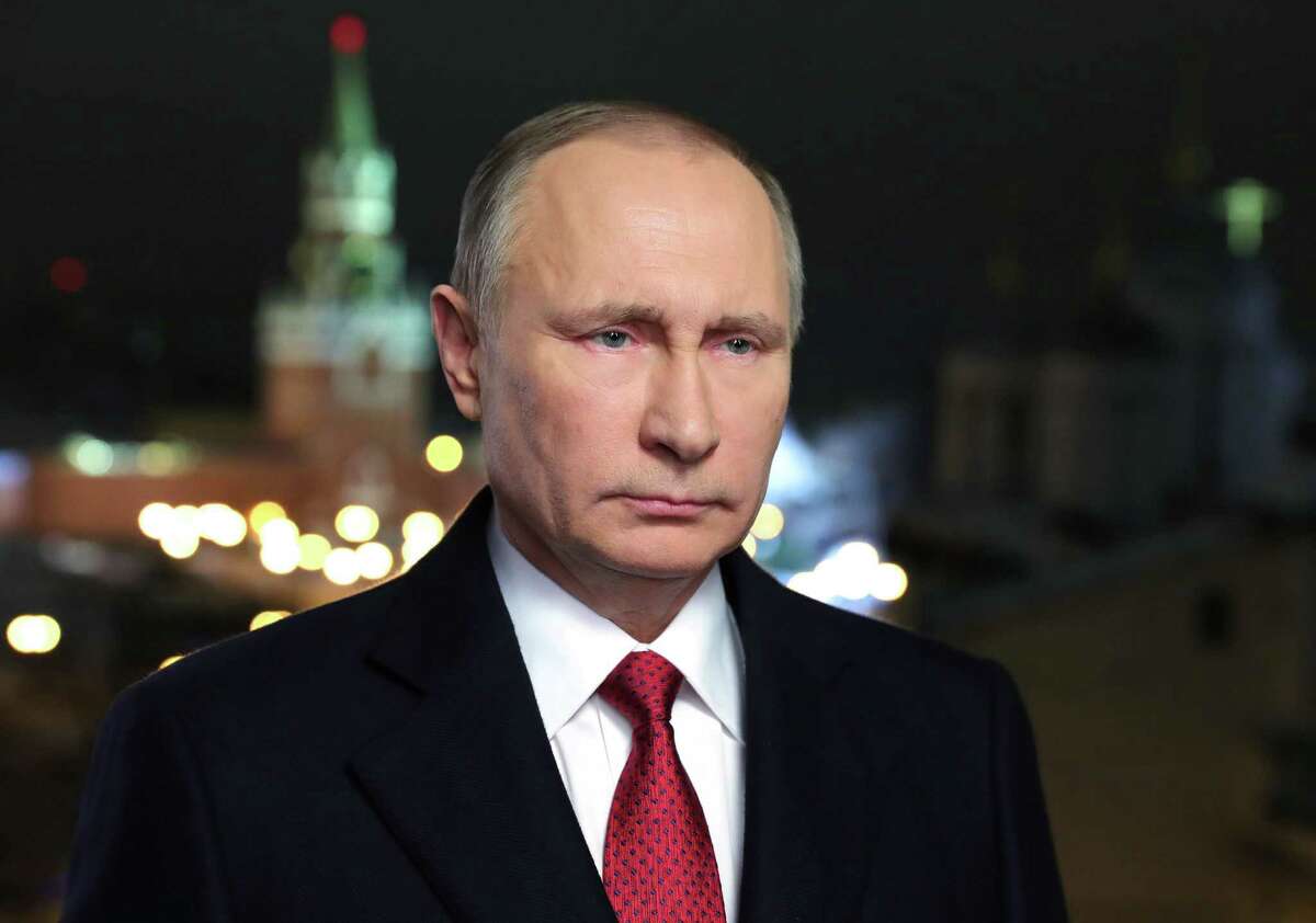 In this photo released by the Kremlin Press service via Sputnik agency, Saturday, Dec. 31, 2016, Russian President Vladimir Putin speaks during an undated recording of his annual televised New Year's message in the Kremlin in Moscow, Russia. President Vladimir Putin invoked a bit of seasonal enchantment in his New Year's Eve remarks to the nation. The recorded message was being televised just before midnight Saturday in each of Russia's nine time zones. (Mikhail Klimentyev/Kremlin Press Service, Sputnik, via AP)
