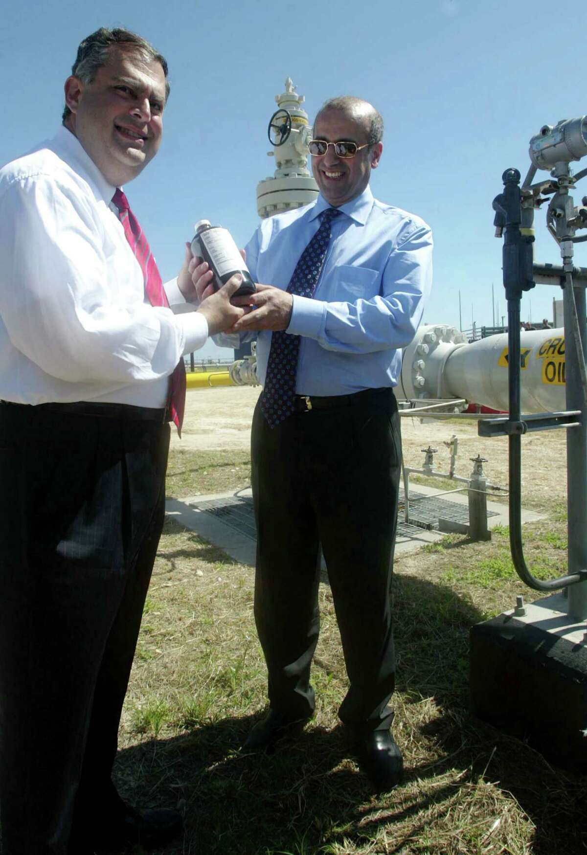 FREEPORT, TX - OCTOBER 1: U.S. Secretary of Energy Spencer Abraham (L) and Russian Minister of Energy Igor Yusufov (R) hold a bottle of crude oil during their tour of the U.S. Strategic Petroleum Reserve's Bryan Mound facility October 1, 2002 in Freeport, Texas. Abraham said that the Bush administration will not touch the crude oil stockpile unless there is a "major supply disruption." (Photo by James Nielsen/Getty Images)