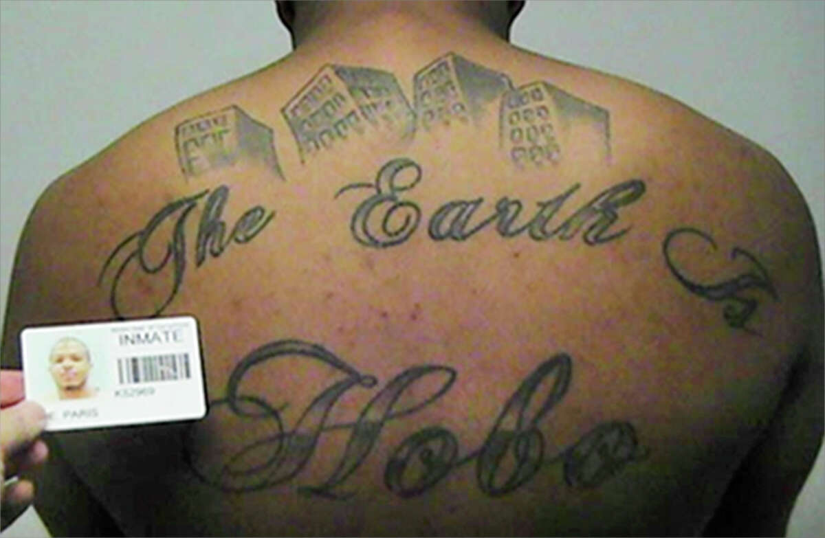 FILE - This undated file photo in a court filing provided by the United States Attorney's office in Chicago, shows Paris Poe's back tattoo that reads "The Earth Is Our Turf", and Hobo. Poe is one of six defendants on trial for racketeering and other charges are purported leaders of the widely feared Hobos, a South Side gang that federal prosecutors said murdered, maimed and tortured their way into control of some of Chicago's most lucrative drug markets. (United States Attorney's office in Chicago via AP file)