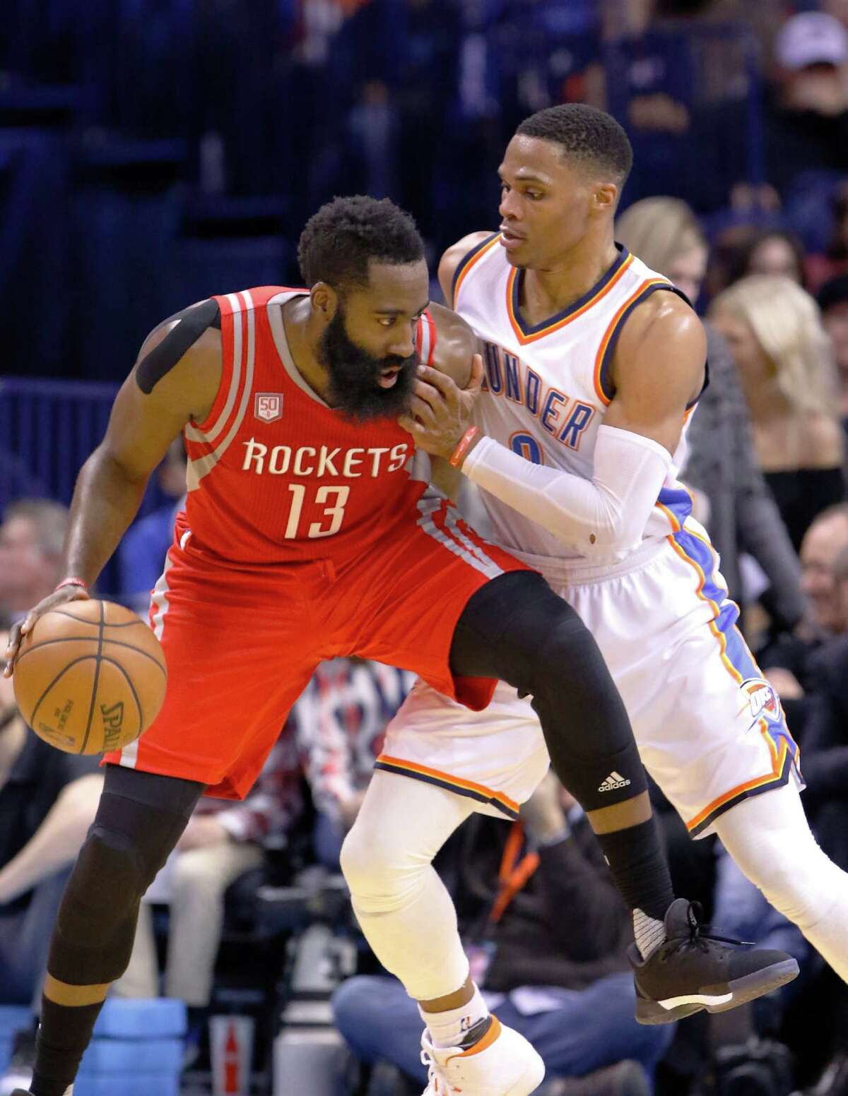 Houston Rockets guard James Harden (13) is defended by Oklahoma City Thunder guard Russell Westbrook (0) on a drive to the basket during the second half of an NBA basketball game in Oklahoma City, Friday, Dec. 9, 2016. Houston won 102-99. (AP Photo/Alonzo Adams)