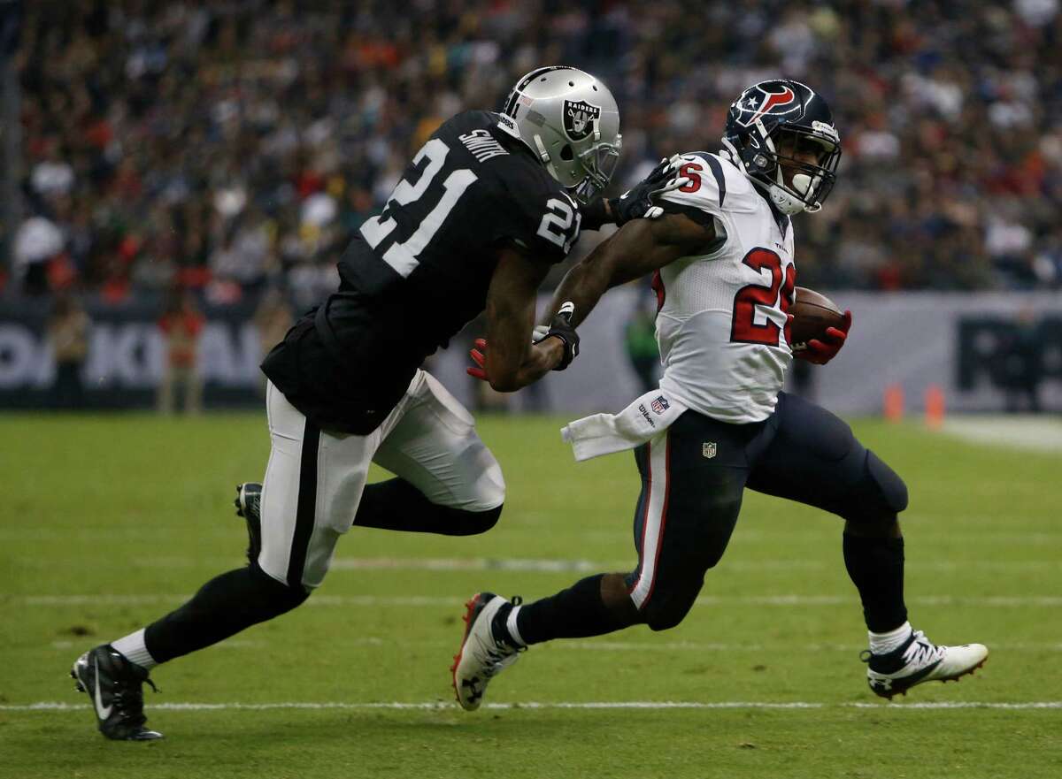 Texans running back Lamar Miller shrugs off Raiders cornerback Sean Smith en route to a 104-yard, one-touchdown performance against Oakland.