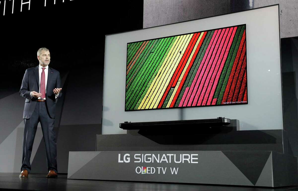 David VanderWaal, vice president of marketing for LG Electronics USA, unveils the LG Signature OLED TV W during an LG news conference before CES International, Wednesday, Jan. 4, 2017, in Las Vegas. (AP Photo/John Locher)