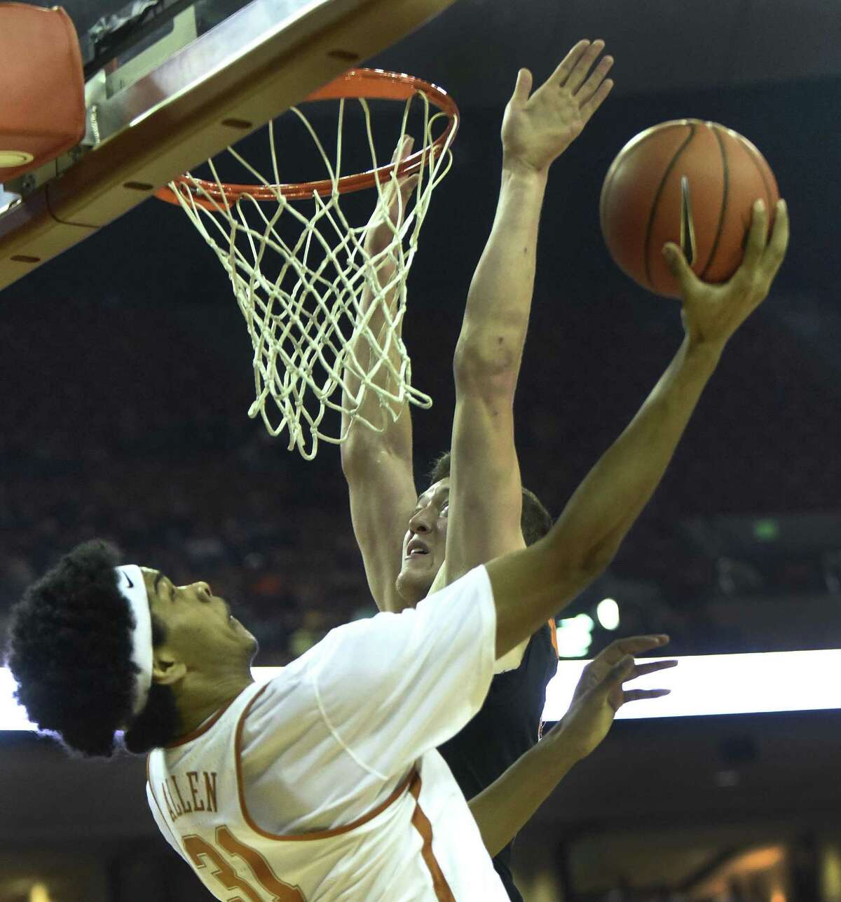 Jarrett Allen of Texas is fouled as she goes under the basket against Oklahoma State's Mitchell Solomon during first-half Big 12 action in Austin on Wednesday, Jan. 4, 2017.