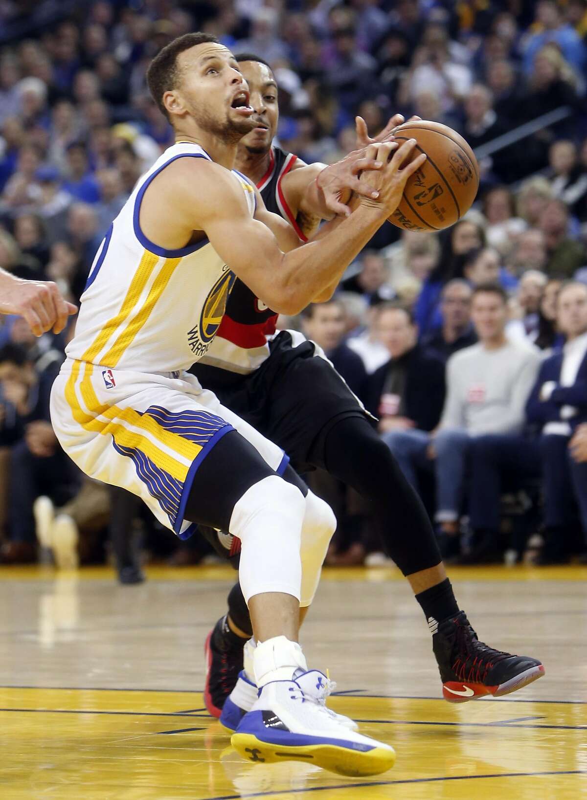 Golden State Warriors' Stephen Curry has the ball knocked away by Portland Trail Blazers' C.J. McCollum in 2nd quarter during NBA game at Oracle Arena in Oakland, Calif., on Wednesday, January 4, 2017.