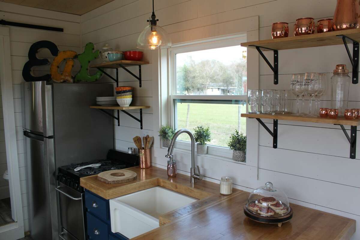 Floating shelves help the kitchen feel more open.