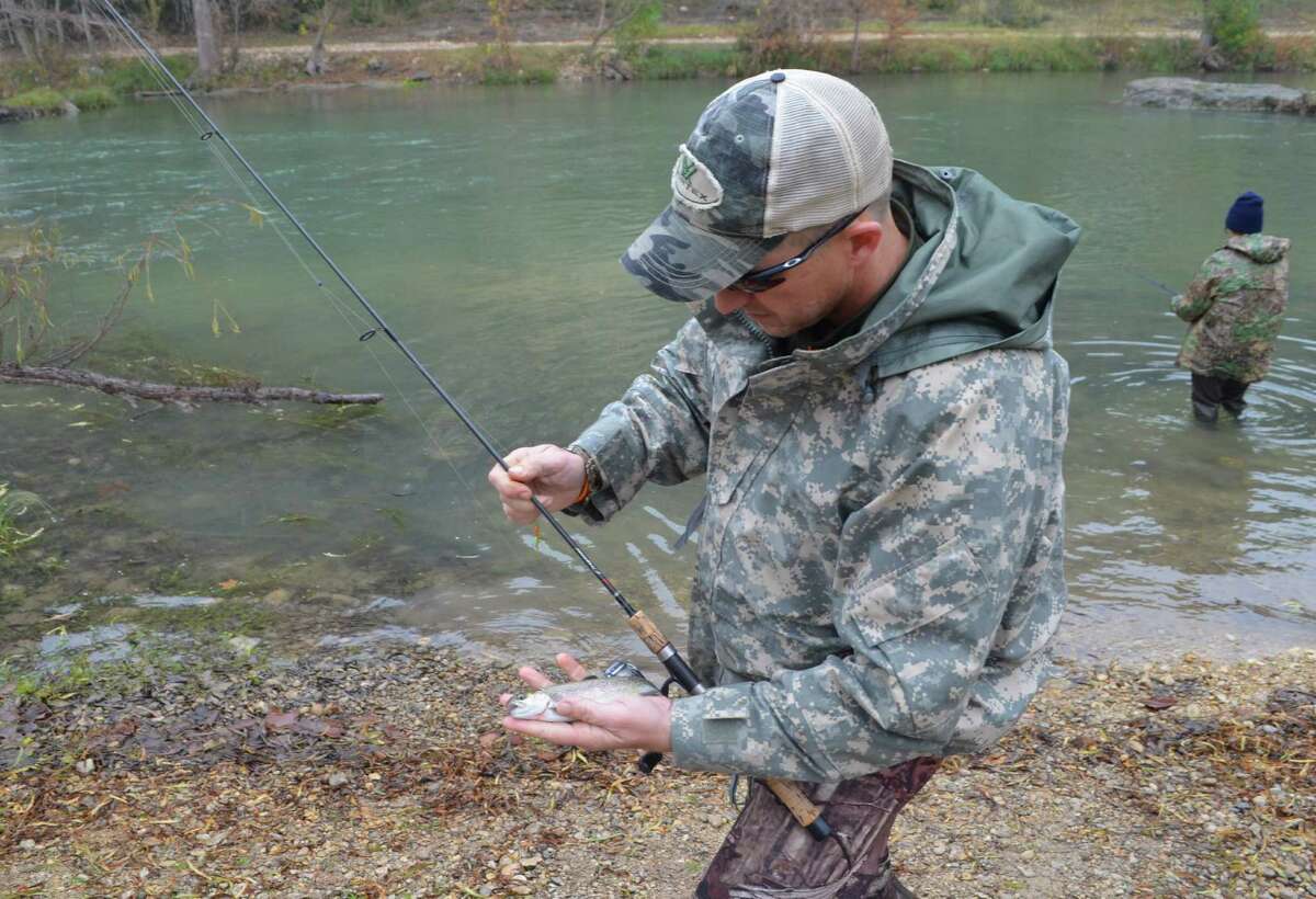 Taking one last look before returning this rainbow trout to the Guadalupe River, Matt Lowell is a regular angler taking advantage of the fishing opportunities at Camp Huaco Springs.
