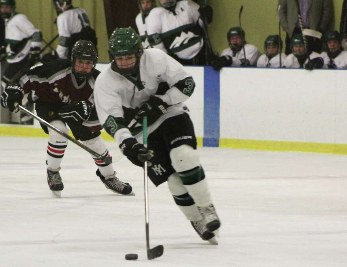 The New Milford High School boys ice hockey team played their first home scrimmage against Farmington Valley. New Milford lost 7-1. Above, junior Ryan Berry make a move during the game.