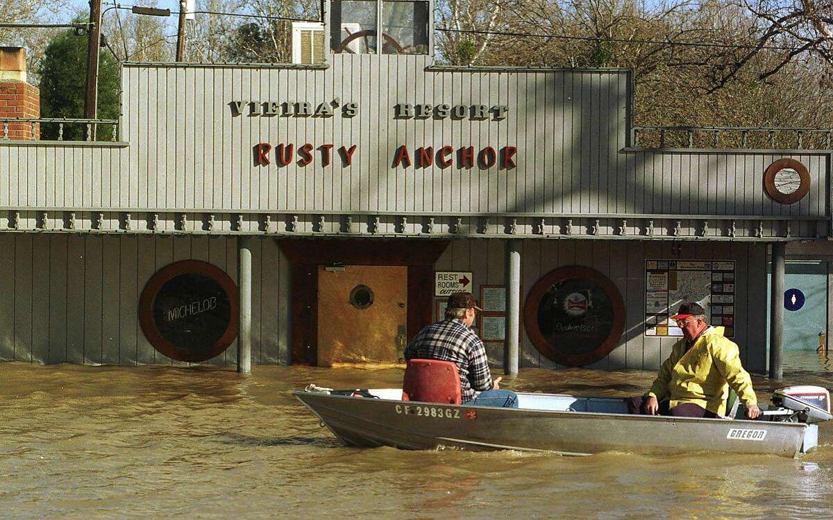 FLOOD 4/C/06JAN97/CD/VM =Home owners on their way to their flooded homes by boat in front of the flooded Rusty Anchor at Vieiras Resort on the Sacramento river in the delta. by Vince Maggiora