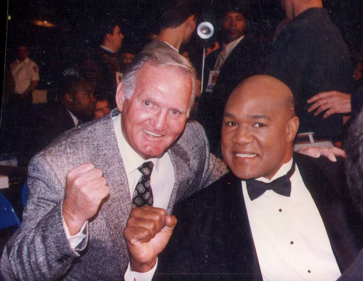 Longtime boxing timekeeper Bill Gavin poses with former world champion George Foreman at an event. Gavin, 86, died Dec. 20 at his North Side home; he had been diagnosed with melanoma.
