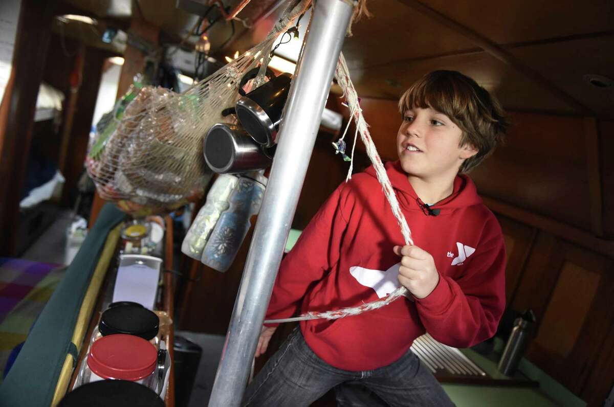 Andri Schwörer, 10, shows the main cabin room in his family's 50-foot sailboat . Climatologist Dario Schwörer, his wife Sabine and their five children are the leaders of the TOPtoTOP Global Climate Expedition, which has circumnavigated the globe conducting field-based research, visiting remote regions and sharing solutions to protect and preserve the planet from climate change. The family lives on the boat, which made a two-week stop in Greenwich before heading off to sea again after the New Year.