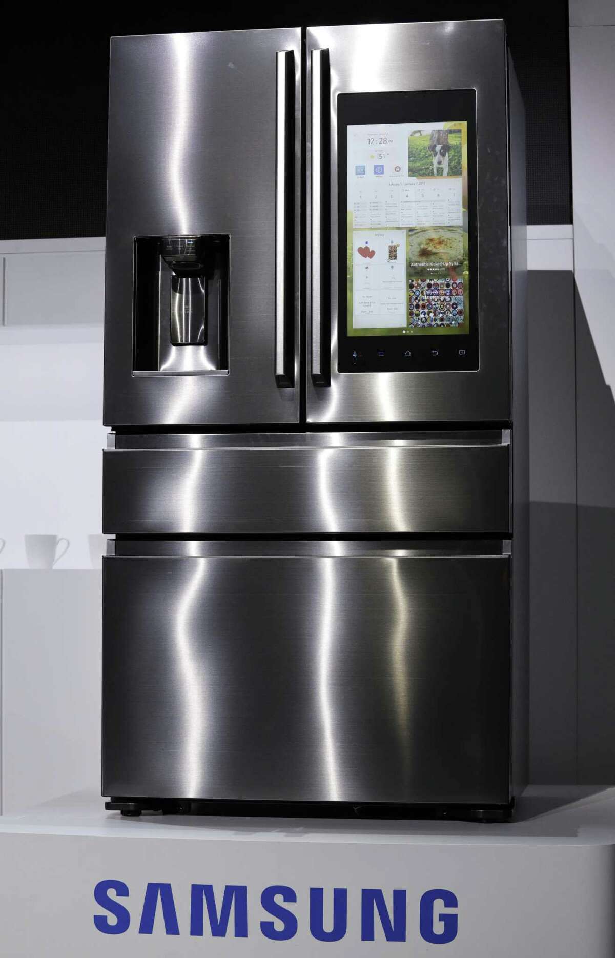 A refrigerator with Family Hub 2.0 is on display during a Samsung news conference before the CES tech show in Las Vegas. Family Hub 2.0 features an interface on the refrigerator with apps that can be controlled by voice recognition.