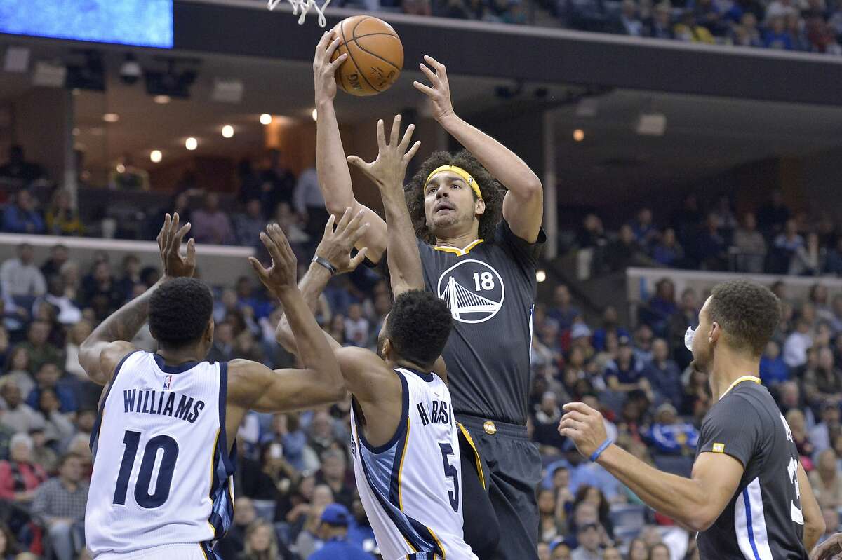 Golden State Warriors center Anderson Varejao (18) shoots against Memphis Grizzlies forward Troy Williams (10) and guard Andrew Harrison (5) as Warriors guard Stephen Curry (30) looks on in the first half of an NBA basketball game Saturday, Dec. 10, 2016, in Memphis, Tenn. (AP Photo/Brandon Dill)