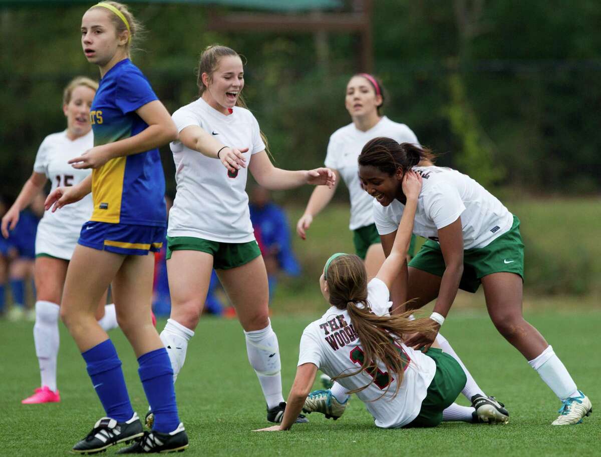 The Woodlands' Jazzy Richards (16) hugs Julia Snider (10) as Ana Helmert (5) runs over after Richards' goal over Klein keeper Annabel Sweeney during the first period of a girls high school soccer match at the Lady Highlander Invitational Thursday, Jan. 5, 2017, in The Woodlands. The Woodlands defeated Klein 4-2.