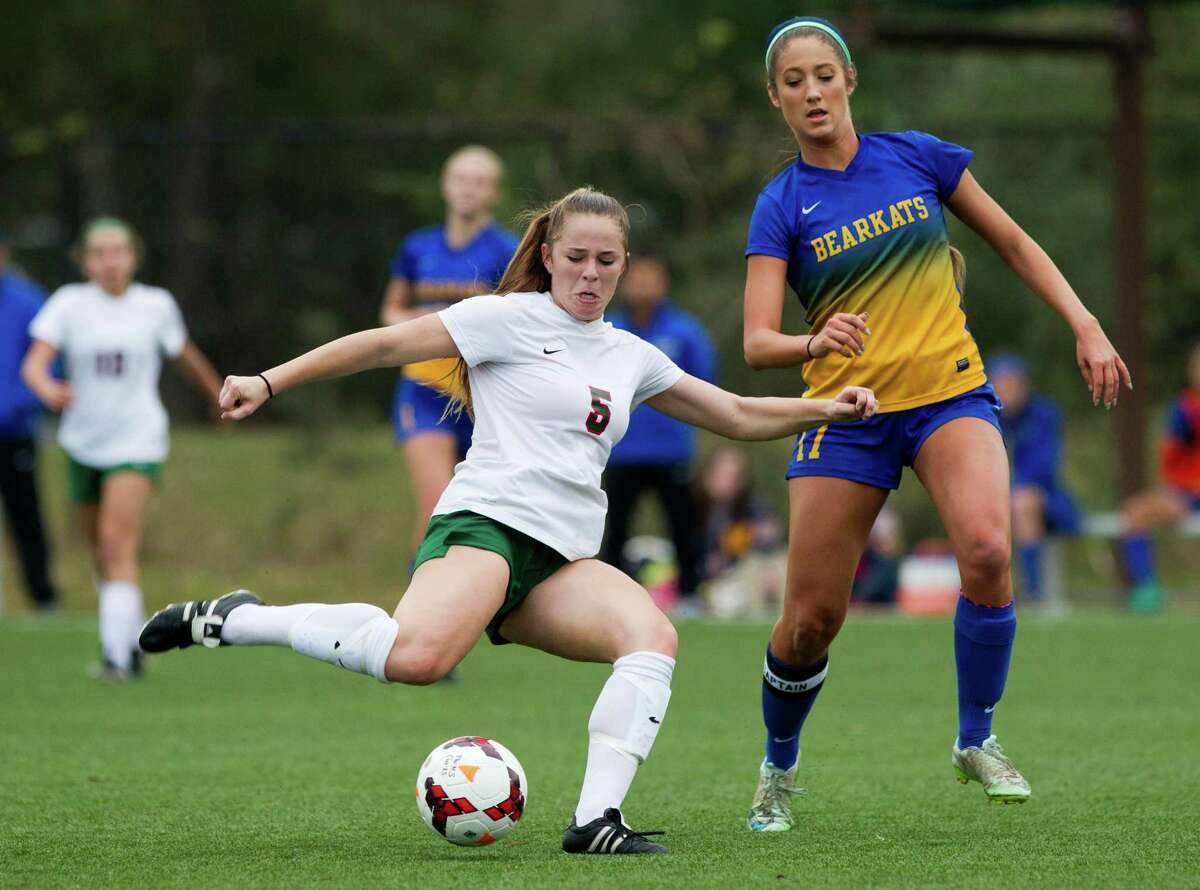 The Woodlands' Ana Helmert (5) takes a shot on goal past Klein's Riley Kaderli (17) during the first period of a girls high school soccer match at the Lady Highlander Invitational Thursday, Jan. 5, 2017, in The Woodlands. The Woodlands defeated Klein 4-2.