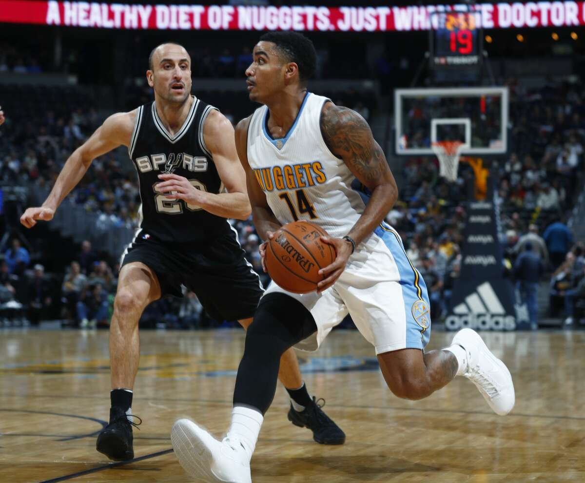 Denver Nuggets guard Gary Harris, front, drives to the rim past San Antonio Spurs guard Manu Ginobili, of Argentina, in the first half of an NBA basketball game Thursday, Jan. 5, 2017, in Denver. (AP Photo/David Zalubowski)
