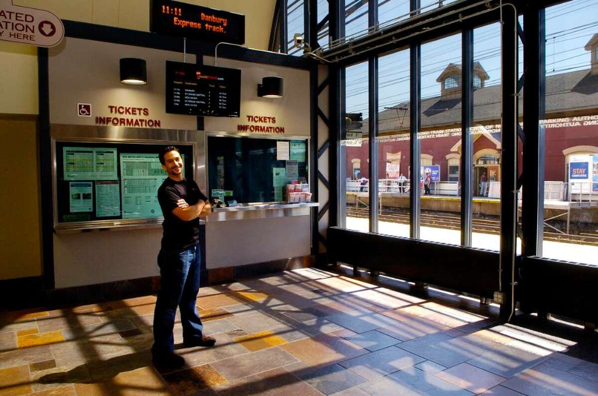 David Marcus, founder of Routefriend, stands in front of one of the departure screens at the South Norwalk train station in Norwalk, Conn. on Tuesday may 25, 2010.