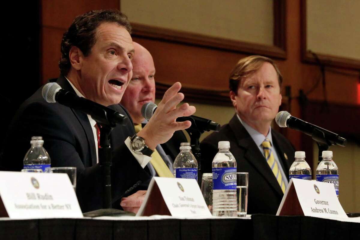 New York Gov. Andrew Cuomo, left, accompanied by MTA Chairman Thomas Predergast, center and New York State Dept. of Transportation Commissioner Matthew Driscoll, makes an infrastructure announcement during the Association for a Better New York luncheon, in New York, Wednesday, Jan. 4, 2017. (AP Photo/Richard Drew)
