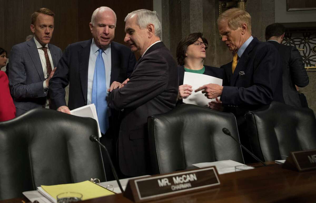 Sen. John McCain (R-Ariz.), second left, the committee chair, speaks with Sen. Jack Reed (D-R.I.) at a Senate Armed Services Committee hearing on foreign cybersecurity threats, on Capitol Hill in Washington, Jan. 5, 2017. McCain has called for a select committee to investigate Russian interference in the election. At right is Sen. Bill Nelson (D-Fla.) (Stephen Crowley/The New York Times)