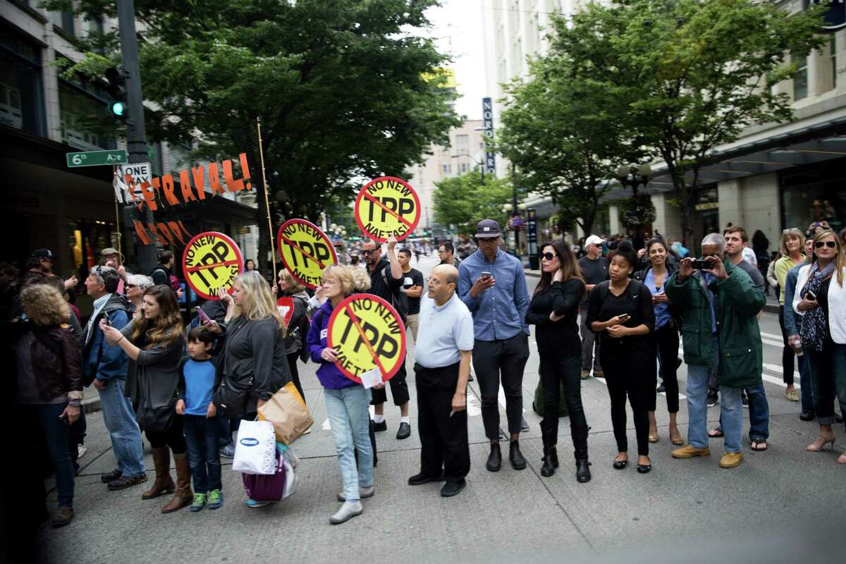 People protest the Trans-Pacific Partnership in Seattle in 2016. A reader suggests President Donald Trump’s decision to pull out of the TPP in 2017 might affect his trade war with China.