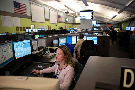 Kate Buhagiar, a dispatcher, takes a call at the 911 dispatch center, on Friday, Oct. 28, 2016 in San Francisco, Calif.
