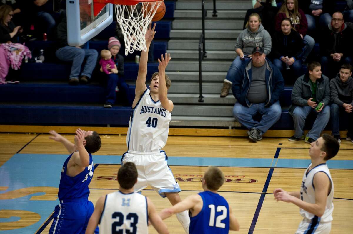 BRITTNEY LOHMILLER | blohmiller@mdn.net Meridian's Lucas Lueder shoots a lay-up in the first half of the Friday evening game against Gladwin.