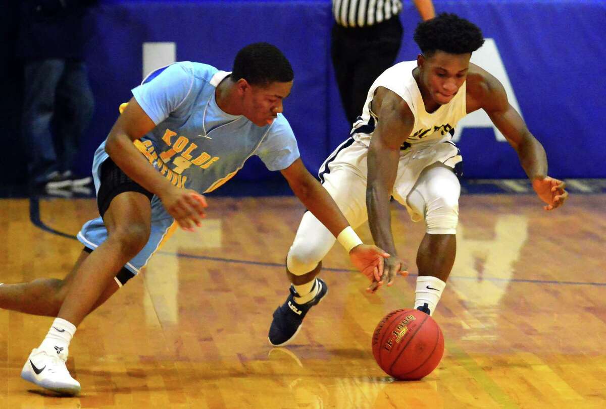 Kolbe Cathedral's Anthony Senior, left, and ND’s Woodley Monnexant reach for a loose ball Friday.