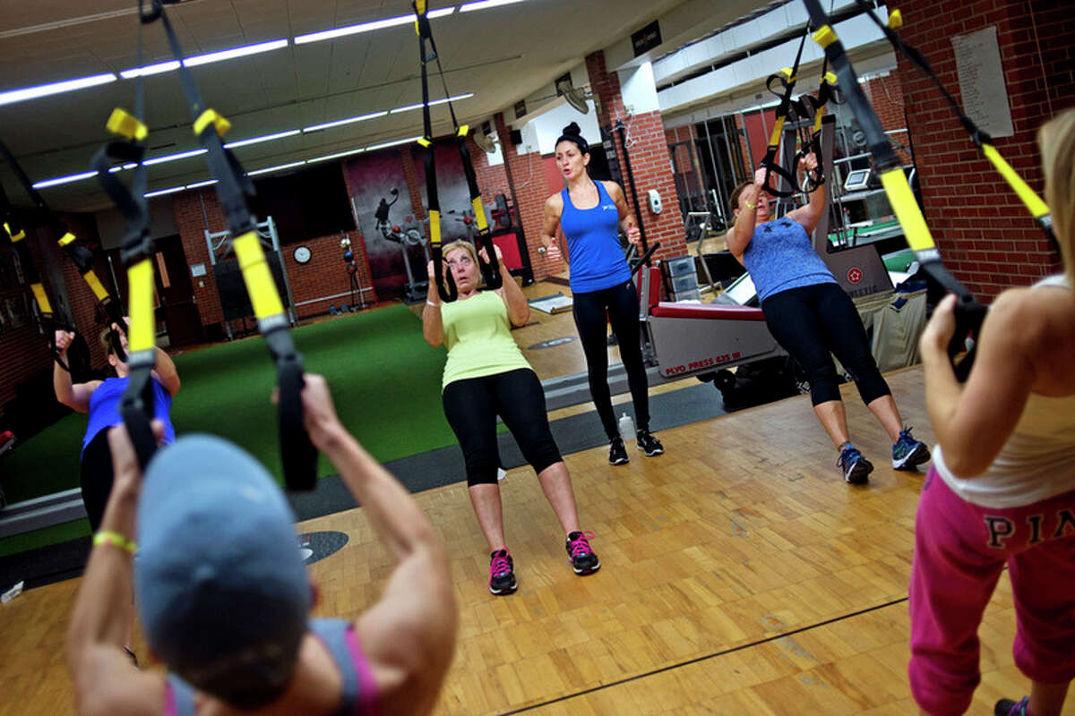 ERIN KIRKLAND | ekirkland@mdn.net TRX Fitness Instructor Andrea Shepherd leads the class on Friday at the Greater Midland Community Center. TRX is a form of resistance and strength training that uses suspension ropes.