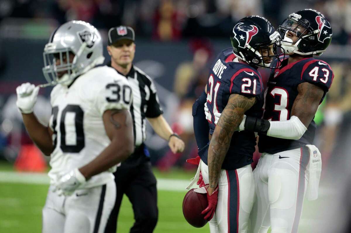 Houston Texans cornerback A.J. Bouye (21) and strong safety Corey Moore (43) celebrate Bouye's interception of a pass by Oakland Raiders quarterback Connor Cook during the fourth quarter of an AFC Wild Card Playoff game at NRG Stadium on Saturday, Jan. 7, 2017, in Houston.