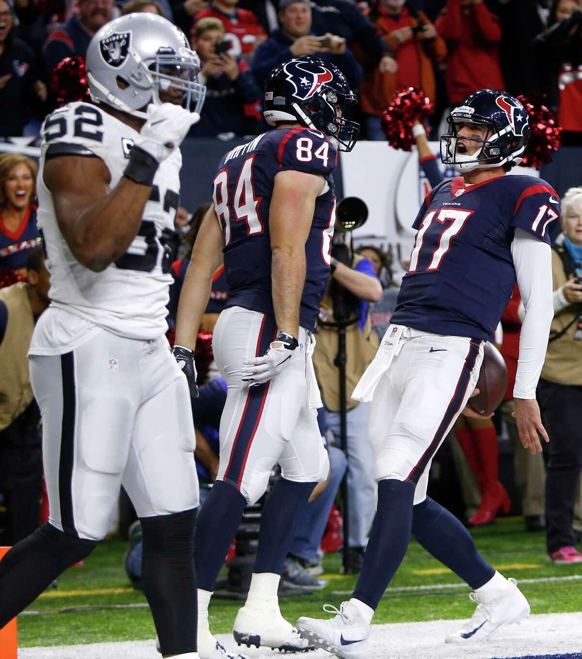 Houston Texans quarterback Brock Osweiler (17) and tight end Ryan Griffin (84) celebrate his the quarterback's 1-yard touchdown run against the Oakland Raiders during the fourth quarter of an AFC Wild Card Playoff game at NRG Stadium on Saturday, Jan. 7, 2017, in Houston.