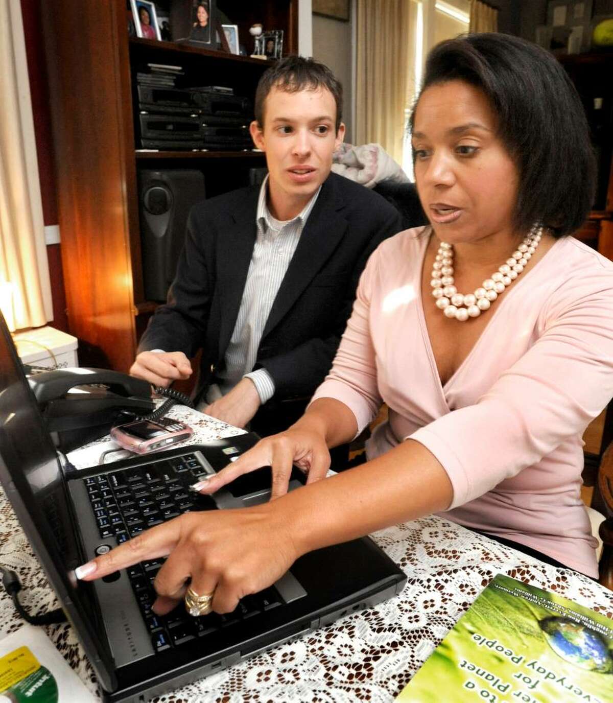 Andrew Wetmore and Gail Hill Williams discuss layout for a book they are co-authoring in Williams home office in danbury on Aug. 31,2009.