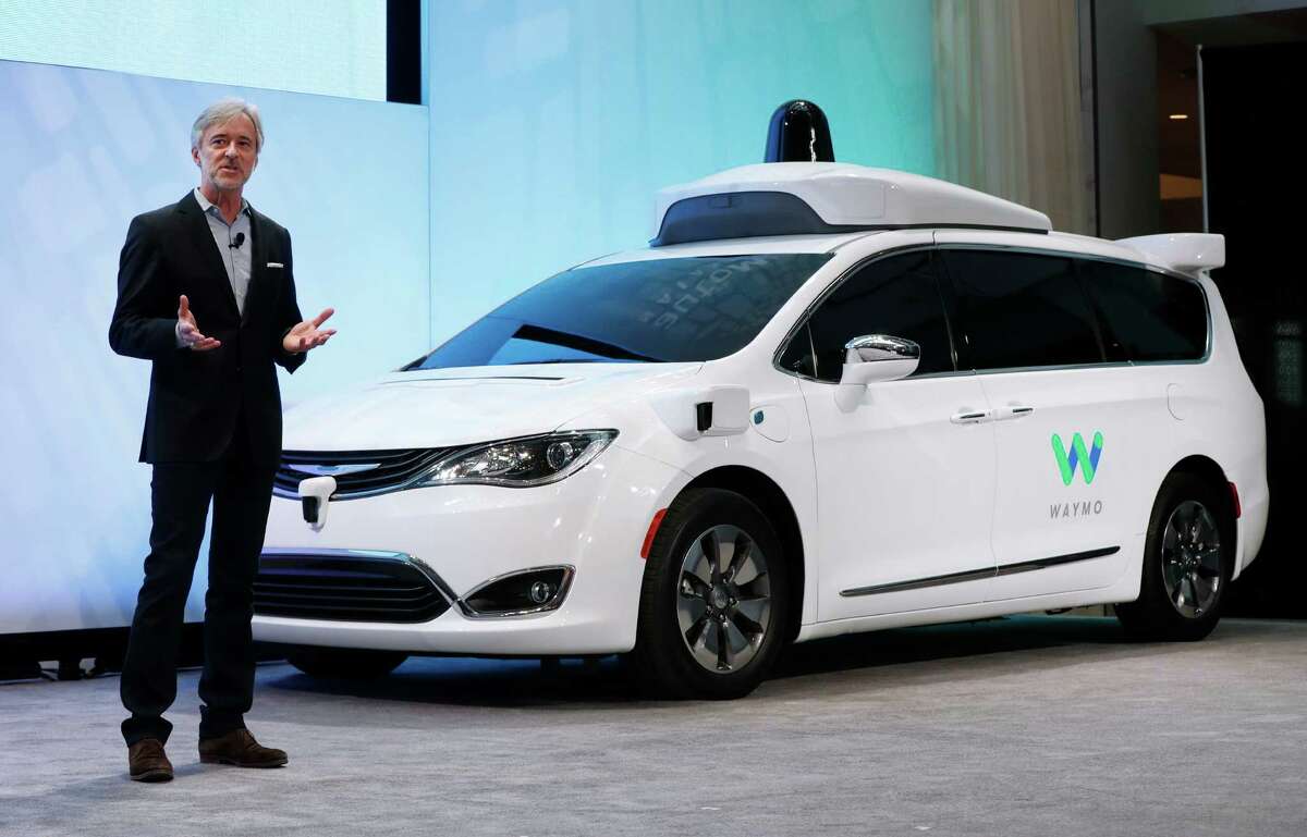John Krafcik, CEO of Waymo, the autonomous vehicle company created by Google's parent company, Alphabet introduces a Chrysler Pacifica hybrid outfitted with Waymo's own suite of sensors and radar at the North American International Auto Show in Detroit, Sunday, Jan. 8, 2017. (AP Photo/Paul Sancya)